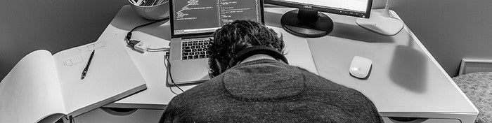 man's head resting on a laptop keyboard