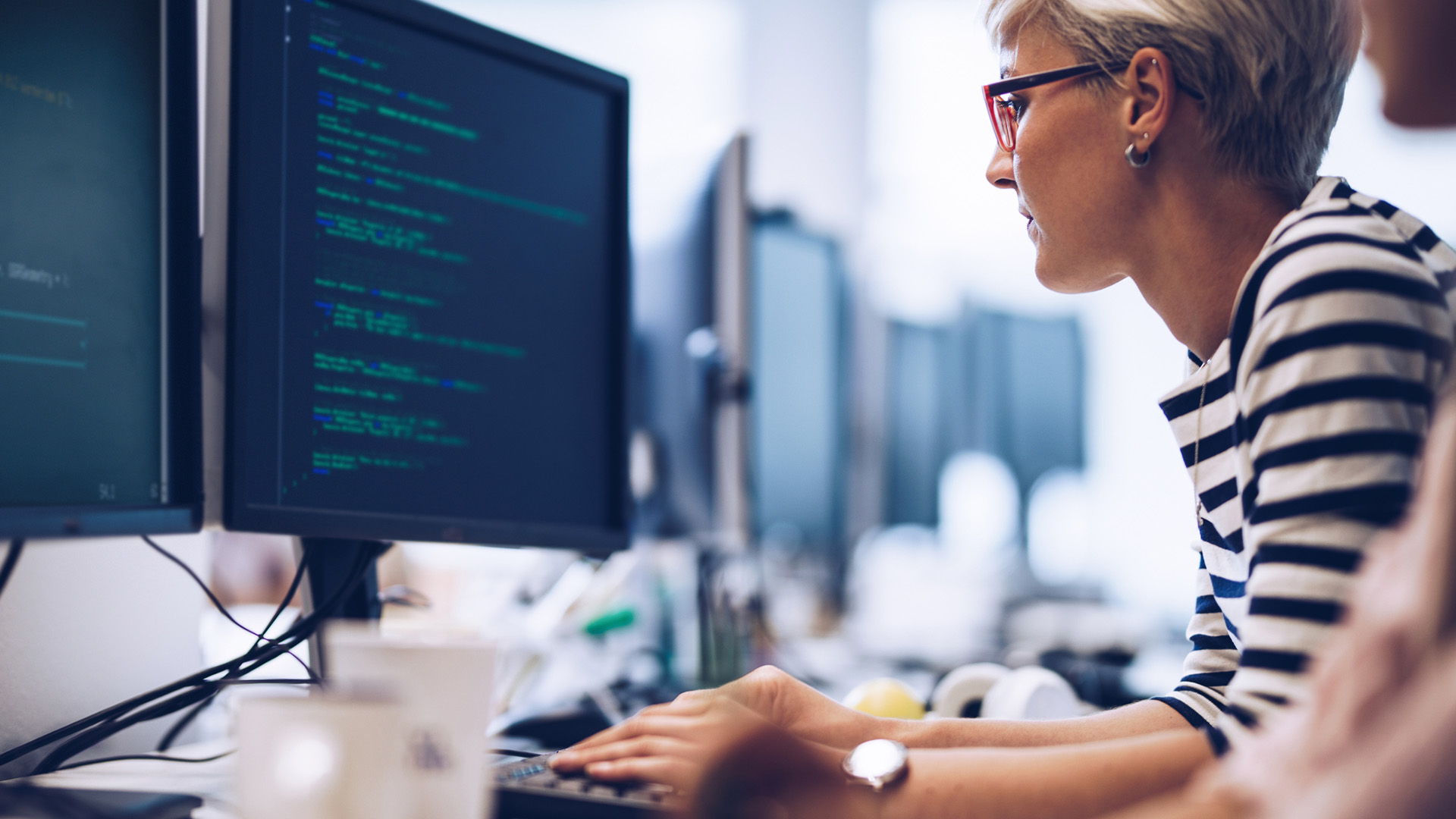 Colleague working on website code on a computer