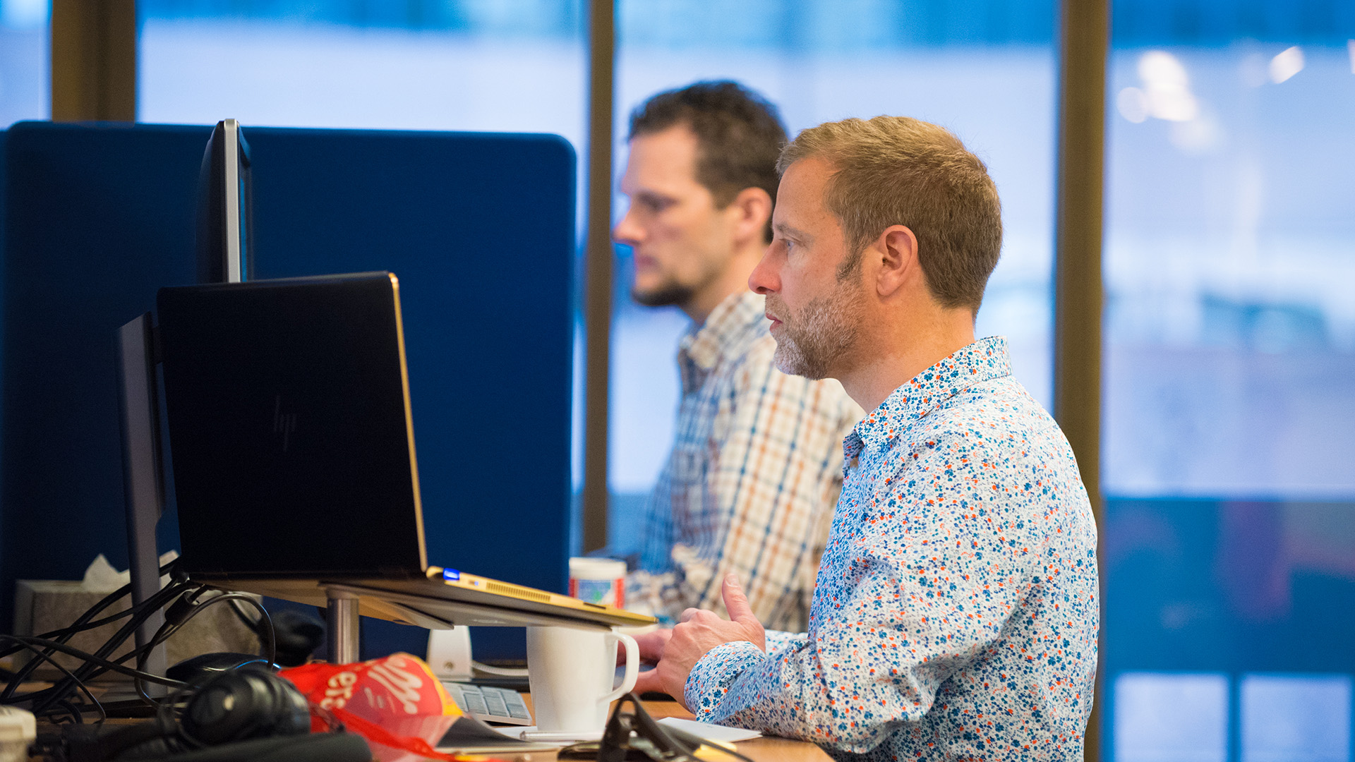 Two colleagues working at their desks