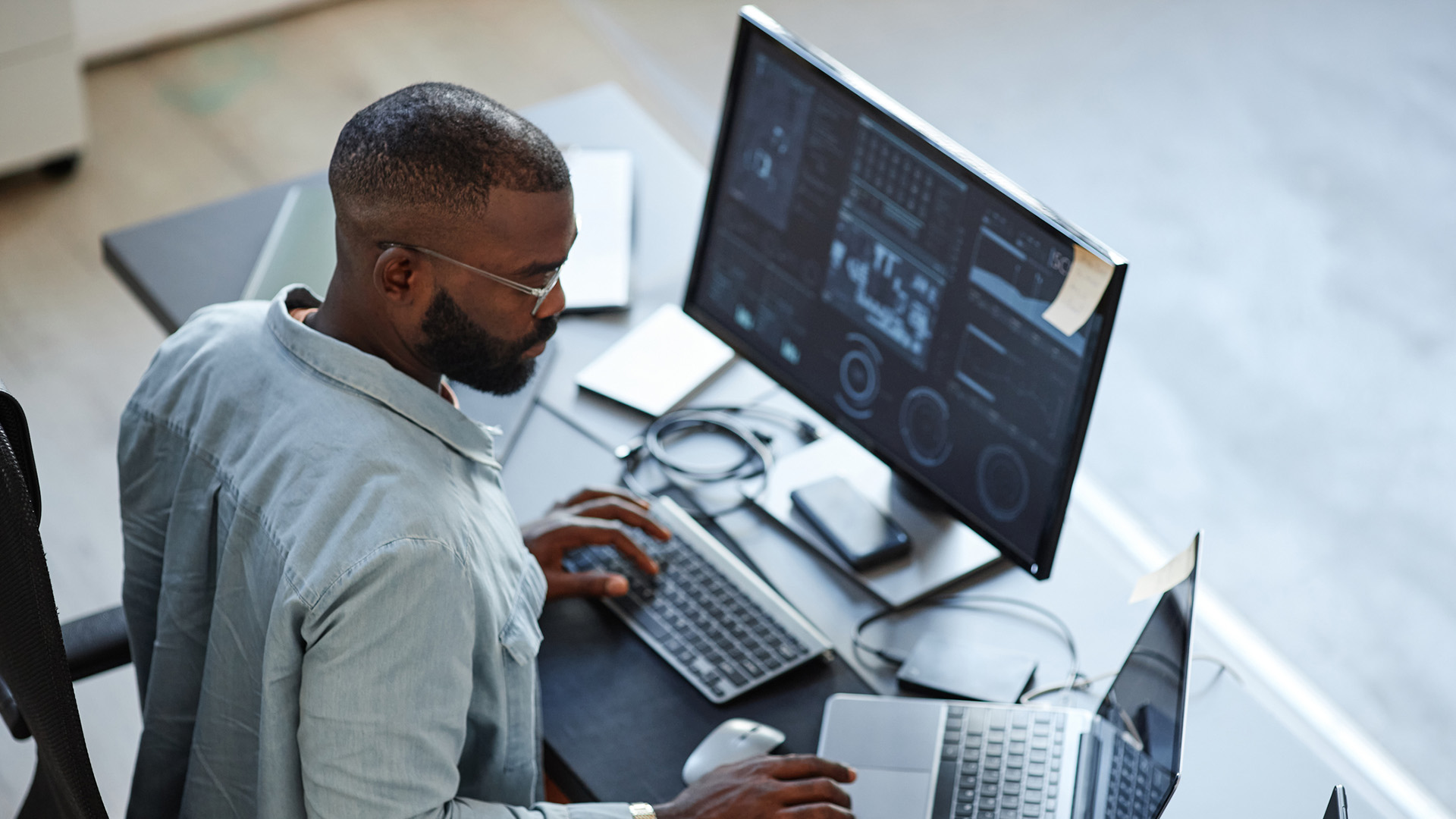 Engineer coding at desk