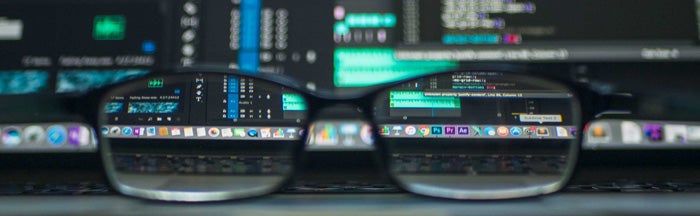 glasses in front of a computer screen