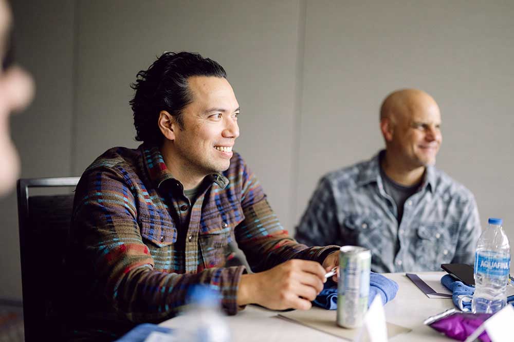 Two colleagues sit at a conference room table